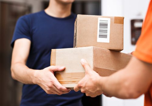 Courier handing packages to a customer at the door