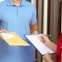 Courier handing documents to a customer