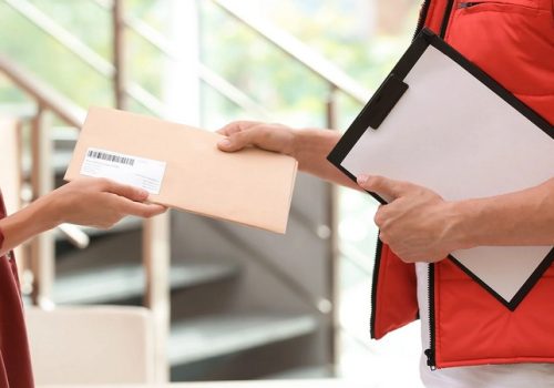 Courier handing an envelope to a customer