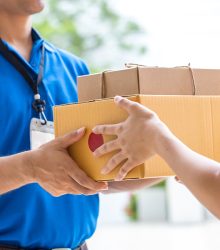 Courier handing a package to a customer